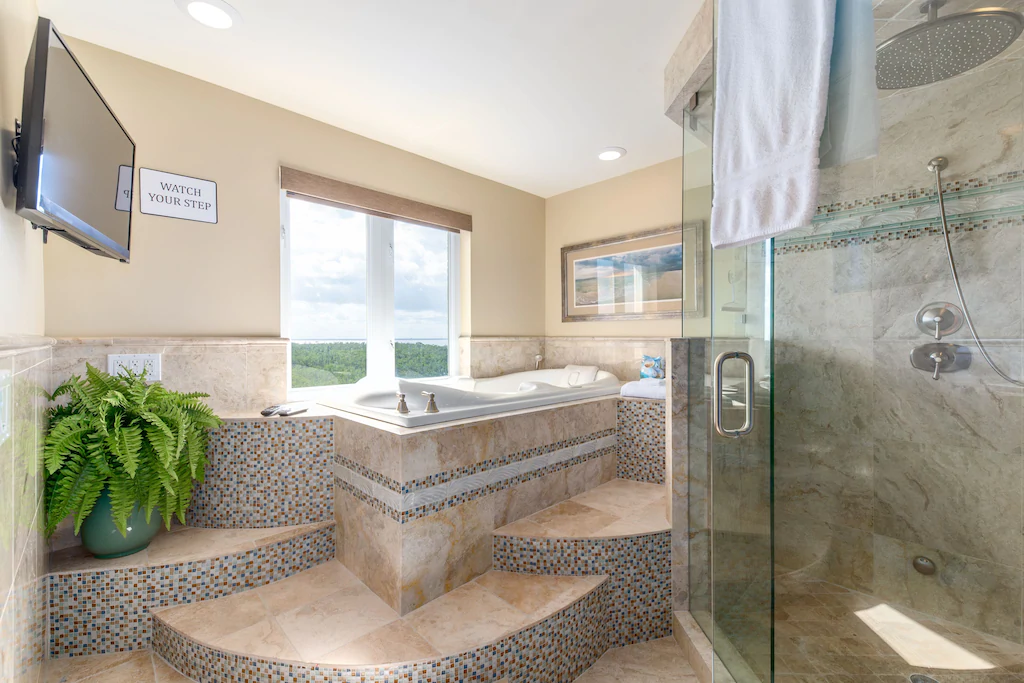 In your master suite, you may watch TV, listen to music, or watch movies (walk-in shower to right)