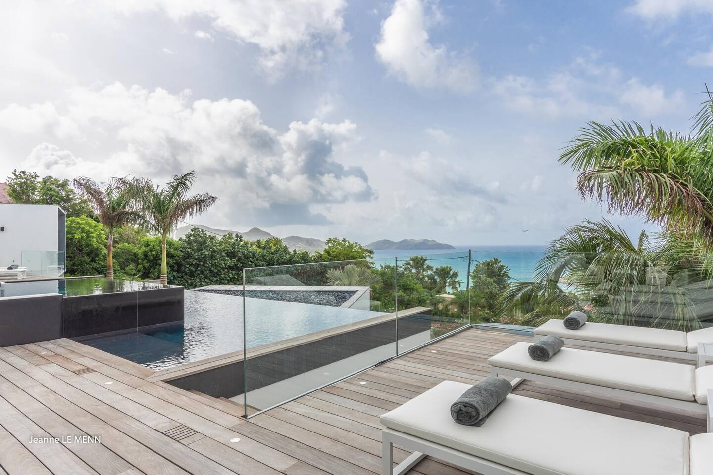 The patio has a heated infinity pool, a Jacuzzi, and plenty of lounge seats.
