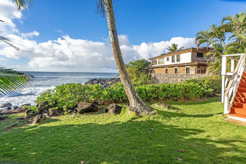 Private green lawn by the beach
