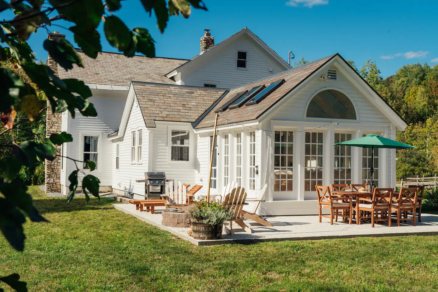 Outdoor patio- handmade fire pit, Weber grill, dining table, and sun lounge chairs.