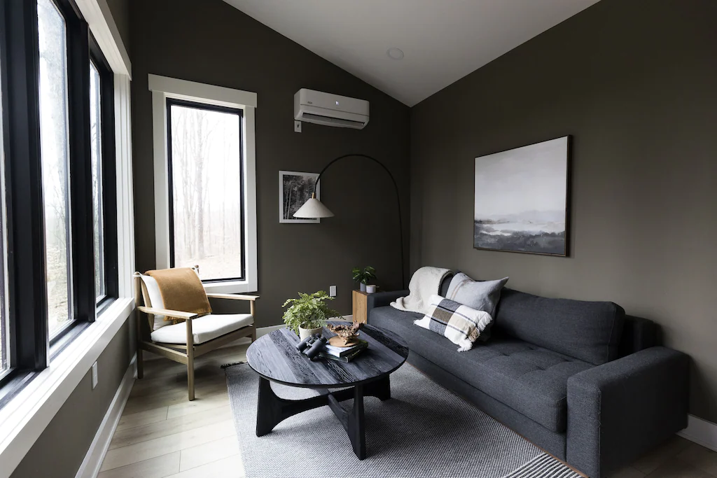 The living room features 4 large windows, and a full size queen sleeper sofa.