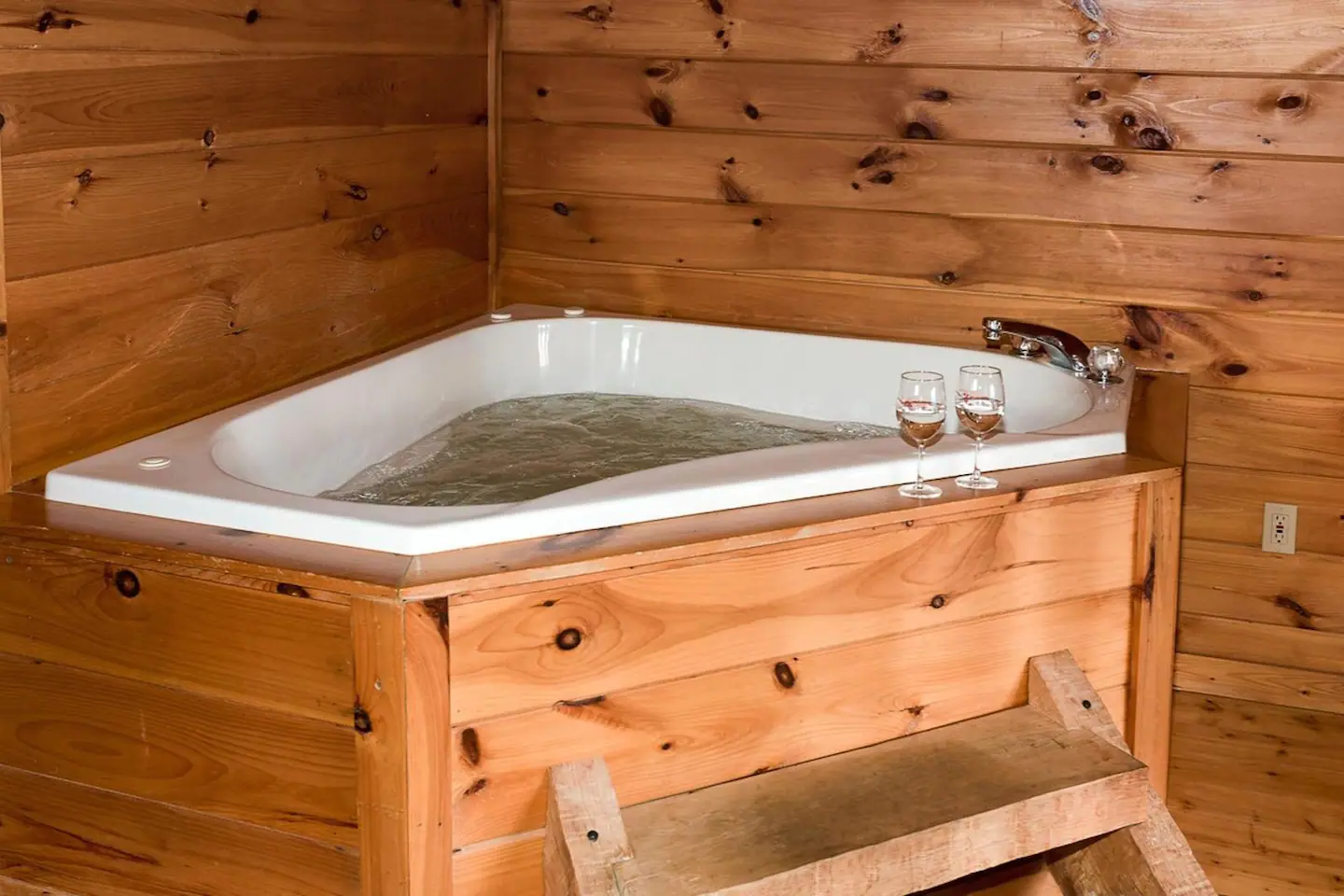 A bathroom with a jetted bath tub
