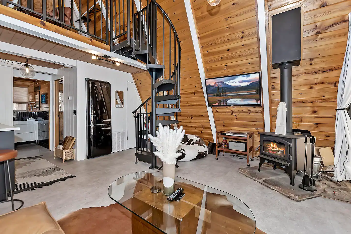 Stairs lead to an upper loft with a king-sized bed.