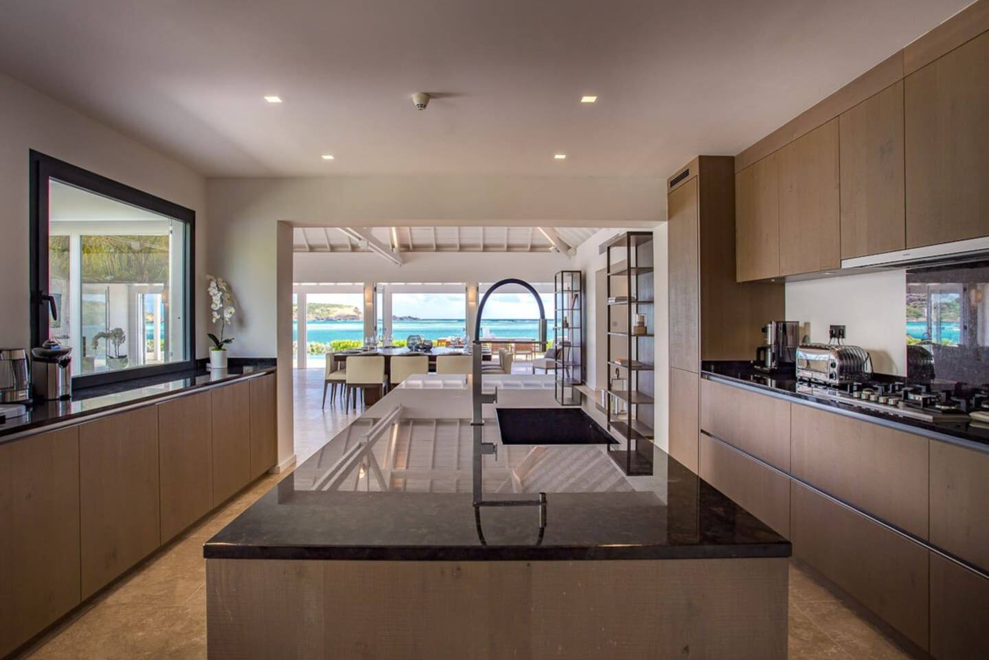 A sleek and modern kitchen with high-end appliances, clean lines, and a minimalist design, creating an elegant and functional space.