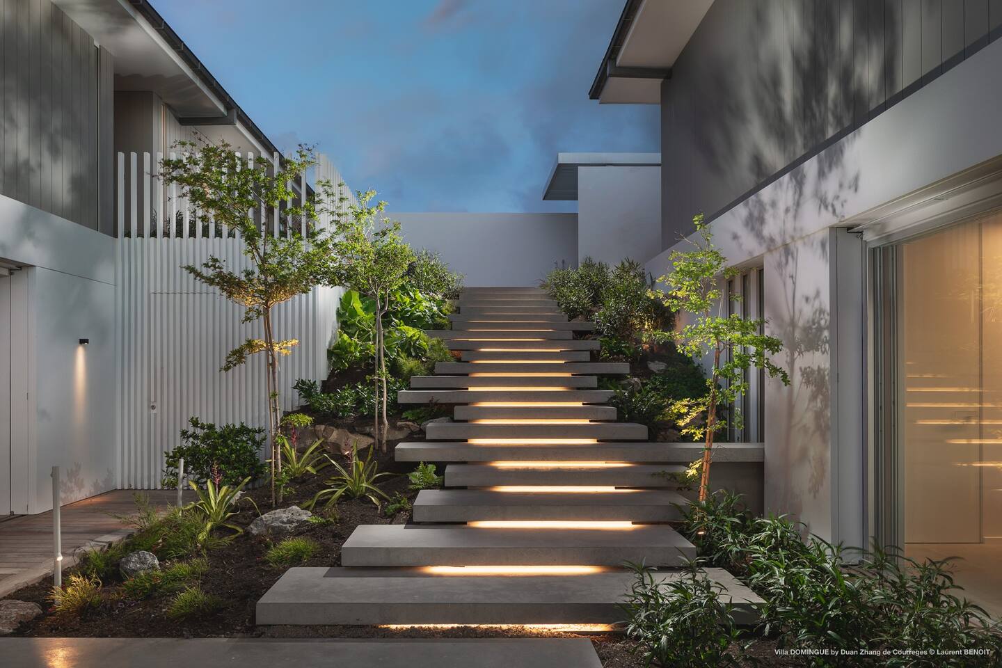 Serene area of the villa's patio stairs, adorned with potted plants and providing a peaceful atmosphere for enjoying the outdoors.
