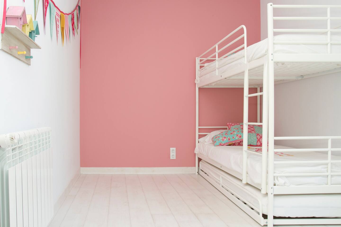 Bedroom with three beds and a bathroom.