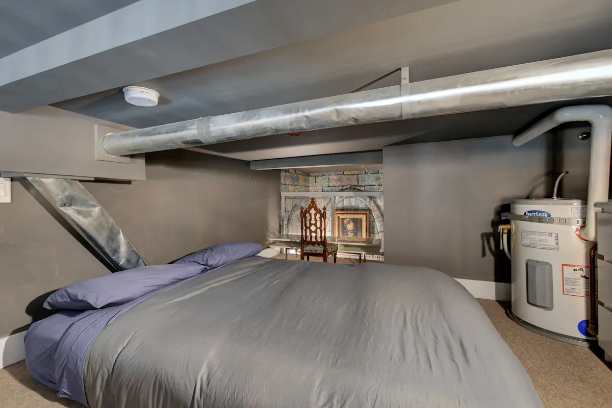 Ascend to the enchanting loft bedroom resembling Gryffindor Common Room. Queen bed overlooks the living area below.