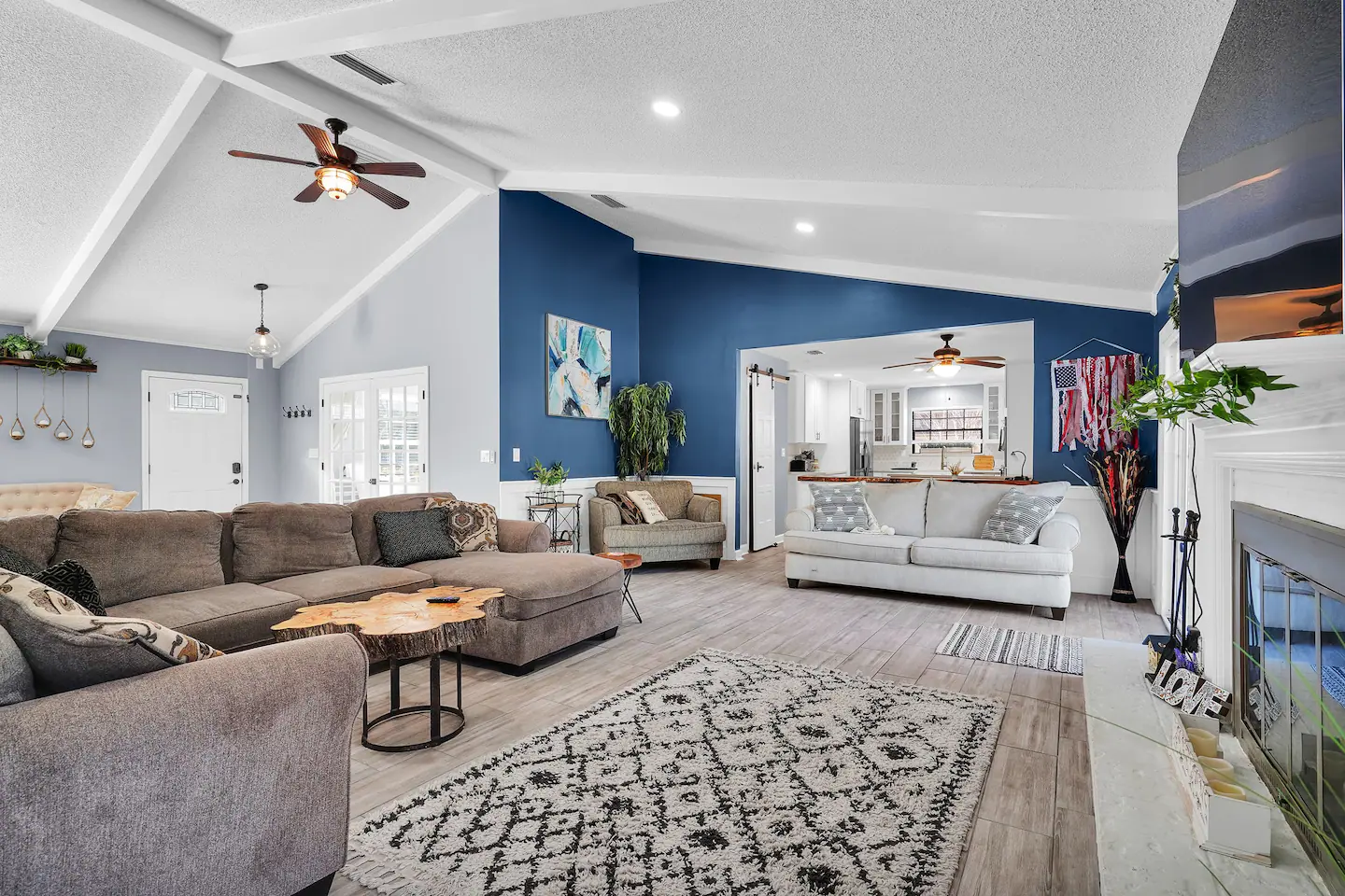 Inside is an open concept living/dining area with tall, vaulted ceilings - perfect for family gatherings.