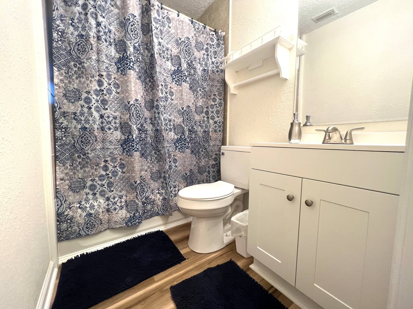 The bathroom is well-equipped with essentials including a bathtub and hairdryer.